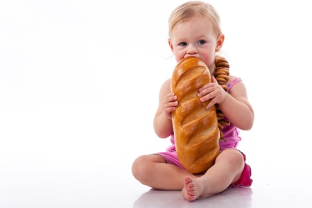 Baby holding a loaf of bread in roll beads isolated on whiteの写真素材