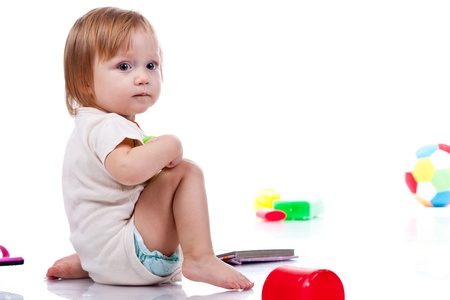 Baby playing with toys isolated on whiteの写真素材