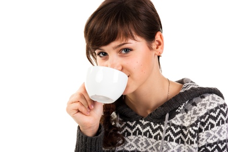 Beautiful girl holding a cup of tea isolated on whiteの写真素材