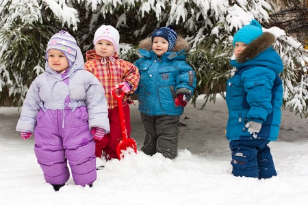 Children playing in snow outdoor in winterの写真素材