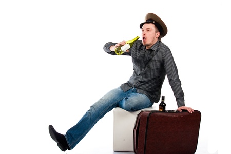 Portrait of a drunk man with a bottle isolated on white の写真素材