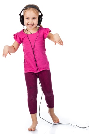 Beautiful girl in headphonesdancing to the music isolated on whiteの写真素材