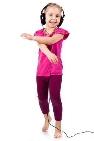 Beautiful girl in headphonesdancing to the music isolated on whiteの写真素材