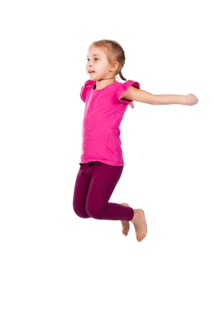 Beautiful girl jumping high isolated on whiteの写真素材