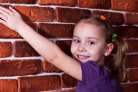 Beautiful smiling girl leaning against the break wall の写真素材