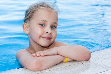 Adorable girl in swimming pool outdoorの写真素材