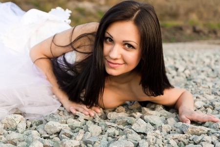 Portrait of a beautiful bride on pebbles outdoorの写真素材