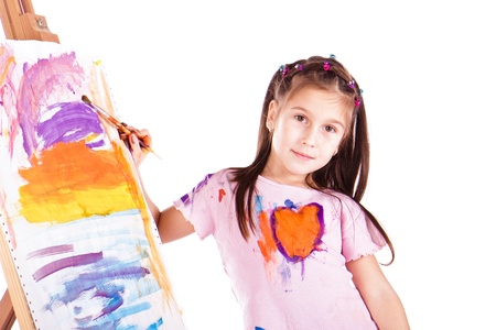 Beautiful little girl painting over white backgroundの写真素材