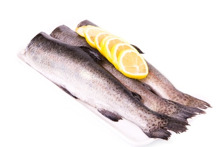 Split trouts with a lemon ready to be cooked isolated on whiteの写真素材