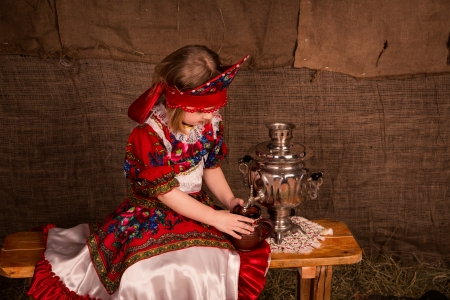 Beautiful russian girl ready to drink tea from samovarの写真素材