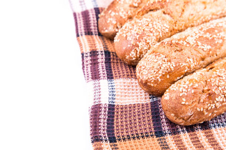 Freshly baked bread rolls with sesame isolated on white