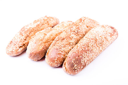 Freshly baked bread rolls with sesame isolated on white