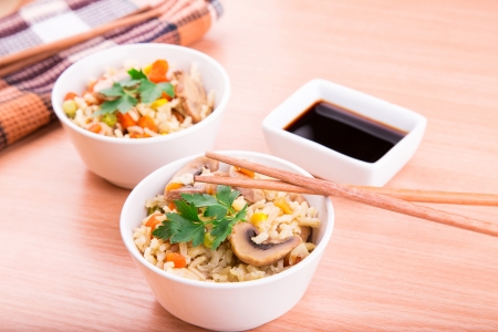 Rice with vegetables and mushrooms with soy sauce servedの写真素材
