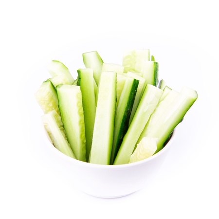 Fresh cucumber ready to eat served on a plate isolated on whiteの写真素材