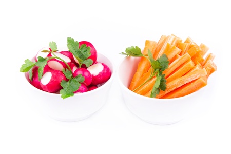 Fresh juicy carrot and radish ready to eat served on a plate isolated on whtieの写真素材