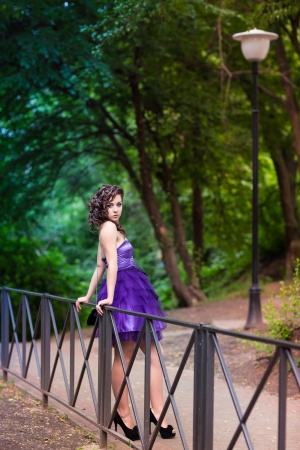 Beautiful young girl in a beautiful dress in the park outdoor の写真素材
