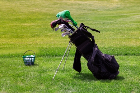 Professional golf equipment  in a golf cart and bucketful of balls on the golf courseの写真素材