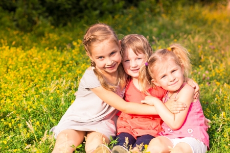 Happy smiling little kids outdoor in the park in summertimeの写真素材