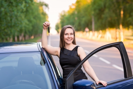 Beautiful businesswoman near her car on the roadの写真素材