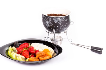 Chocolate fondue with fruits isolated on white backgroundの写真素材
