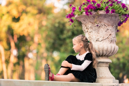 Cute happy smiling little girl in the park outdoorの写真素材