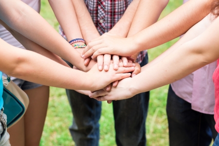 Teens' hands toghether. Support, teamwork, togetherness concept Teens' hands toghether. Support, teamwork, togetherness concept