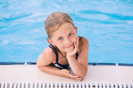 Cute little girl in swimming pool learning how to swimの写真素材