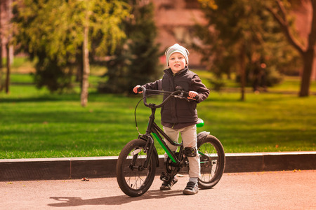 Happy four years old boy learingn how to ride a bike. First riding lessonsの写真素材