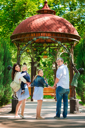 Happy family with two kids enjoying time in the parkの写真素材