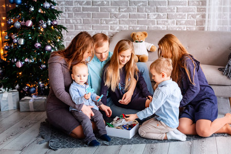 Happy family having fun together near Christmas tree at home