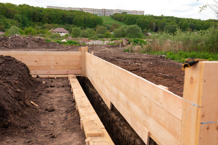 Wooden formwork for creating strip foundation for new house basis. Constructing house from the beginning conceptの写真素材