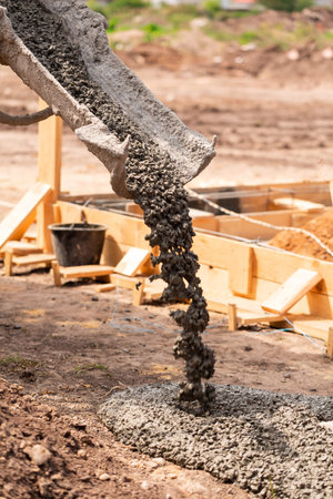 Lay of the cement or concrete into the foundation formwork with automatic pump. Building house...