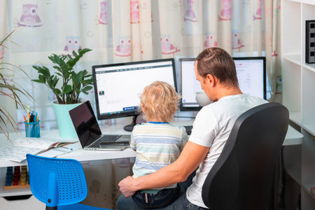 Father with kid trying to work from home during quarantine. Stay at home, work from home concept...