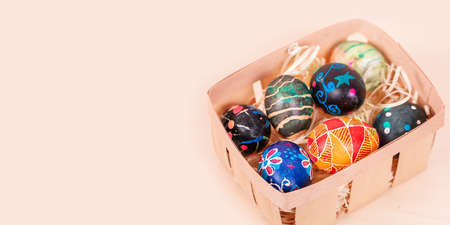 Easter basket with painted eggs banner. Easter holiday tradition. Easter Egg Hunt. Colorful easter eggs. Spring religious holidayの写真素材