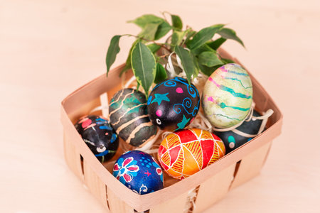 Easter basket with painted eggs. Easter holiday tradition. Easter Egg Hunt. Colorful easter eggs....