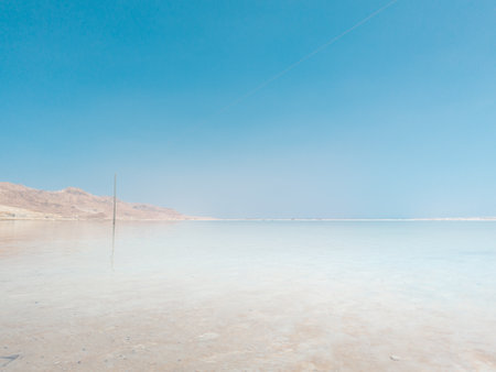 Landscape view on Dead Sea salt crystals formations, clear cyan green calm water at Ein Bokek beach, Israelの写真素材