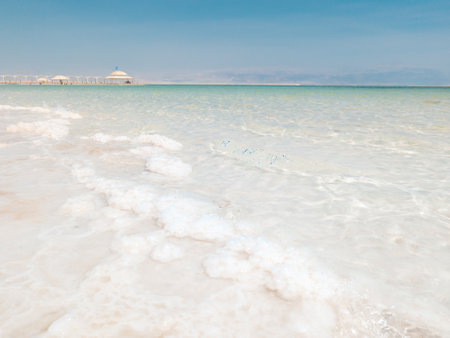 Landscape view on Dead Sea salt crystals formations, clear cyan green calm water at Ein Bokek beach, Israelの写真素材