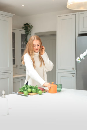 Young woman is preparing in the kitchen. Healthy Food. Salad. Diet. Dieting Concept. Healthy...