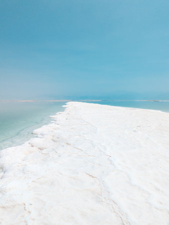 Landscape view on Dead Sea salt crystals formations, clear cyan green calm water at Ein Bokek beach, Israelの写真素材