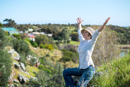 Woman enjoying in nature with arms outstretchedの写真素材