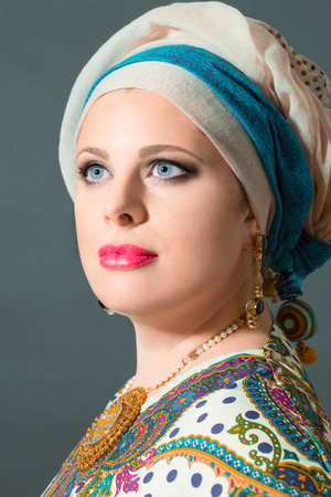 Close up portrait of beatiful  woman  with blue eyes wearing turban,studio shootの写真素材