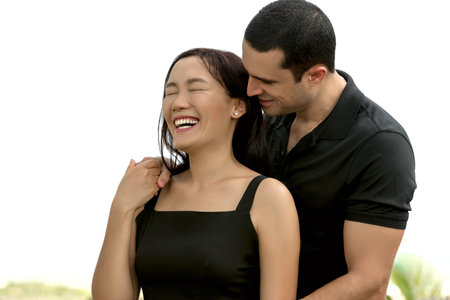 Couple in love enjoying outdoor.Stunning sensual outdoor portrait of interracial happy couple. Asian...