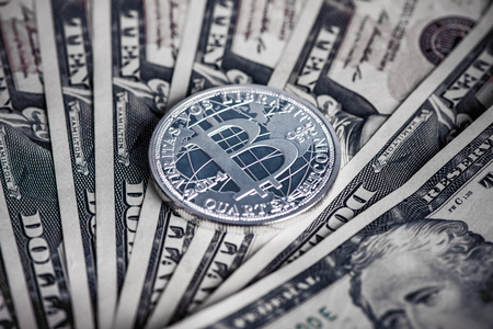 silver bitcoin coin on us dollars close upの写真素材