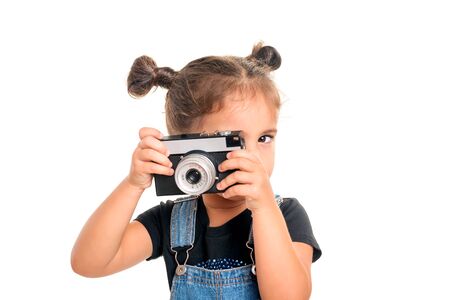 Portrait of cute  baby girl  with vintage camera posing in studio.Isolatedの写真素材