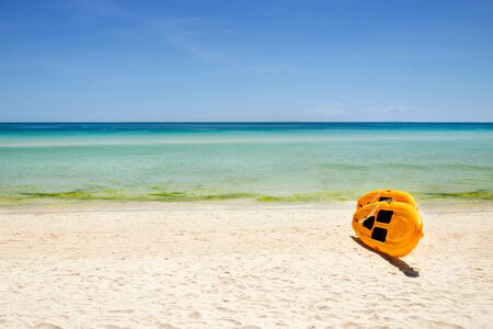 yellow paddle boards and children boats on tropical beach with white sand with copyspaceの写真素材