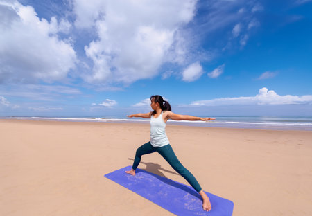 people, fitness, sport and healthy lifestyle concept - young asian woman making yoga pose on...
