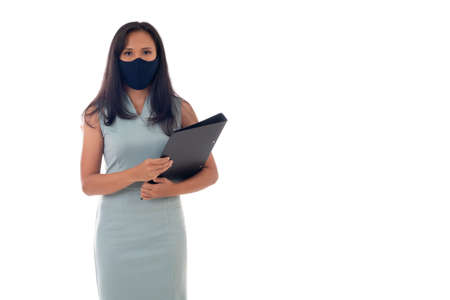 Flu epidemic, dust allergy, protection against virus concept- studio portrait of young asian business woman wearing a face mask, looking at camera, isolated on white background.の写真素材