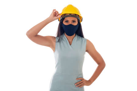 portrait of asian engineer woman with helmet wearing a face mask isolated white backgroundの写真素材