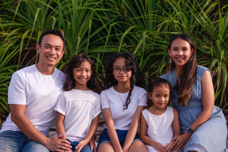 family, leisure and people concept-young active parents with three daughters - enjoying summer...