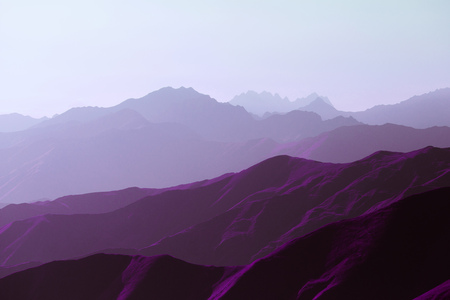 Surrealistic mountain landscape of purple hues. Panorama of rows of ridges against the background of the setting sunの写真素材